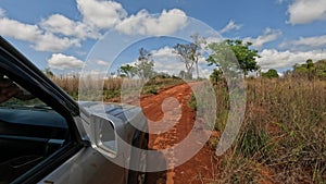 A close-up shot of a tire on a 4x4 vehicle driving through the muddy road from Tsingy de Bemaraha to Morondava in Madagascar