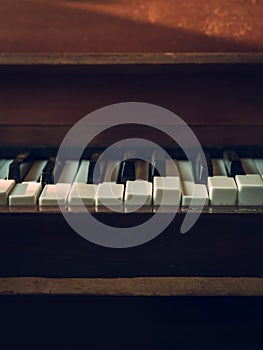 Close up shot to broken piano keys in abandoned house. An ancient musical instrument. Old broken disused piano with damaged keys