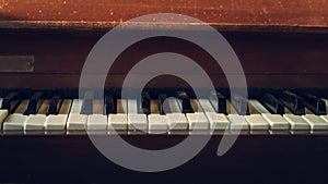 Close up shot to broken piano keys in abandoned house. An ancient musical instrument. Old broken disused piano with damaged keys