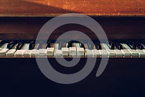 Close up shot to broken piano keys in abandoned house. An ancient musical instrument. Old broken disused piano with damaged keys