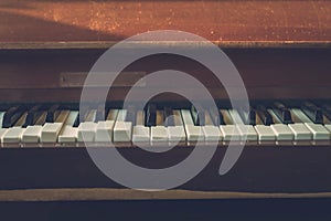 Close up shot to broken piano keys in abandoned house. An ancient musical instrument. Old broken disused piano with damaged keys