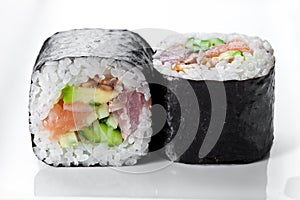 Close up shot of traditional fresh japanese sushi rolls on a white background