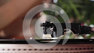 Close-up shot of a turntable stylus reaching the end of a retro style recording. selective focus