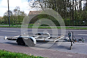 Close up shot of two axle trailer parked next to a street in Aachen, Germany