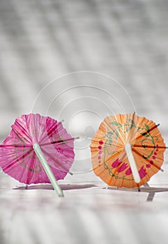 Close-up shot of two cocktail umbrellas.
