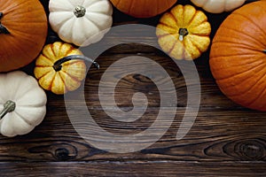 Close up shot of two decorative pumpkins on grunged wood texture background bright as a symbol of autumnal holidays with a lot of