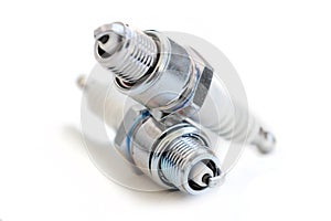 Two spark plugs on white