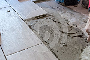 Close up shot of unfinished floor tiles installation in kitchen