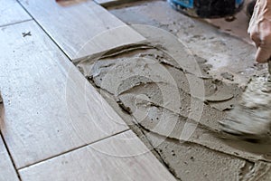 Close up shot of unfinished floor tiles installation in kitchen