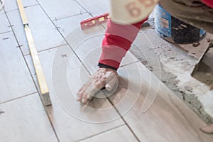 Close up shot of unfinished floor tiles installation in kitchen