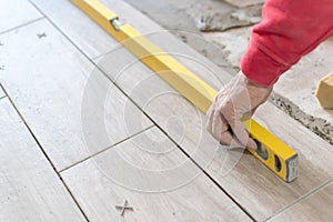 Close up shot of unfinished floor tiles installation in kitchen