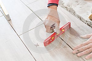 Close up shot of unfinished floor tiles installation in kitchen