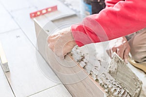 Close up shot of unfinished floor tiles installation in kitchen