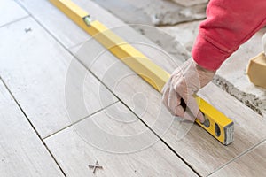 Close up shot of unfinished floor tiles installation in kitchen