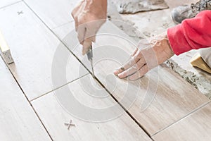 Close up shot of unfinished floor tiles installation in kitchen