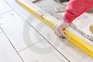 Close up shot of unfinished floor tiles installation in kitchen