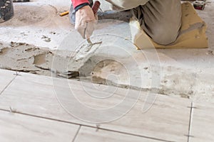 Close up shot of unfinished floor tiles installation in kitchen