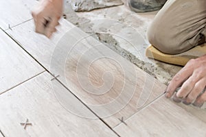 Close up shot of unfinished floor tiles installation in kitchen