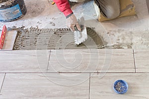 Close up shot of unfinished floor tiles installation in kitchen