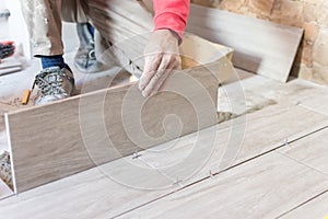 Close up shot of unfinished floor tiles installation in kitchen