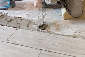 Close up shot of unfinished floor tiles installation in kitchen