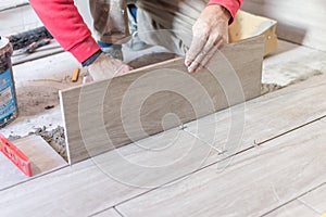 Close up shot of unfinished floor tiles installation in kitchen