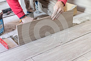 Close up shot of unfinished floor tiles installation in kitchen