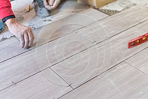 Close up shot of unfinished floor tiles installation in kitchen