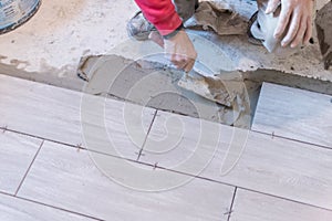 Close up shot of unfinished floor tiles installation in kitchen