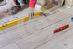 Close up shot of unfinished floor tiles installation in kitchen