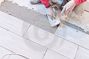 Close up shot of unfinished floor tiles installation in kitchen