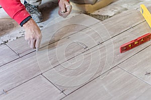 Close up shot of unfinished floor tiles installation in kitchen