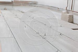 Close up shot of unfinished floor tiles installation in kitchen