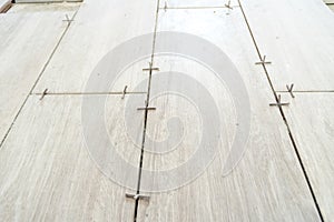 Close up shot of unfinished floor tiles installation in kitchen