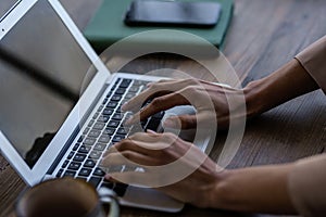 Close-up shot of an unrecognizable woman using laptop