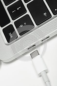 Close up shot of usb c cable plugging to a laptop computer