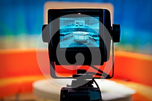 Close-up shot of a video camera viewfinder, recording show in a TV studio