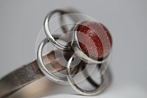 Close-up shot of a vintage flower ring with a goldstone