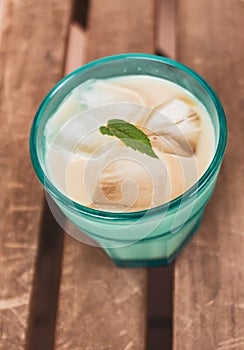 Close up shot of a white Russian alcohol iced drink with mint on top