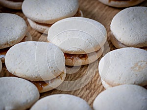 Close-up shot of white sweet alfajor sweets on a wooden table