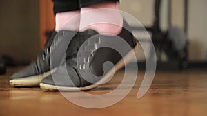 Close-up shot of woman jumping on a skipping rope in a gym. Sports concept