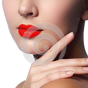 Close-up shot of woman lips with glossy red lipstick. Glamour re