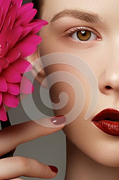 Close-up shot of woman lips with red lipstick and beautiful