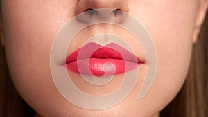 Close-up shot of woman lips with red lipstick. Beautiful perfect lips. Sexy mouth close up.