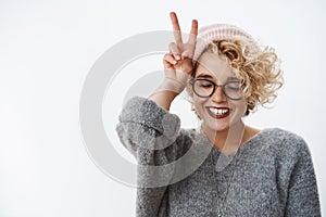 Close-up shot of woman loving winter and holidays having fun feeling happy and tender close eyes joyful wearing beanie photo