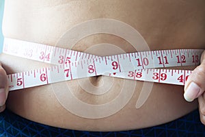 Close up shot of woman measuring waist, Dieting concept