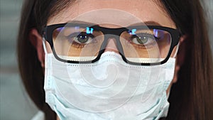 Close up shot of a woman with a poor eyesight who looks like a nurse