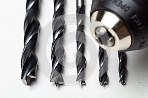 Close-up shot of wood drill bits of different sizes and chuck