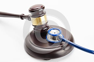 Close up shot of a wooden judge gavel and a stethoscope