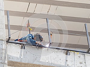 Close up shot of a worker welding in a construction site photo